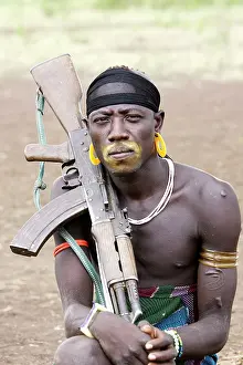 Guns: Mursi people - Man with kalachnikof