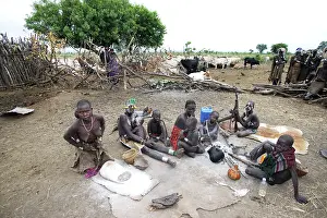 Mursi: Mursi Tribe - village with woman working