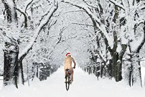 Bicycles: Naked male with Christmas hat on bike riding