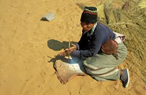 Drilling: Namibia - A Kung Bushman / San woman drills holes