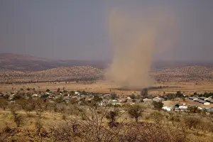 Devil: Namibia, Opuwo. Dust devil forms near town