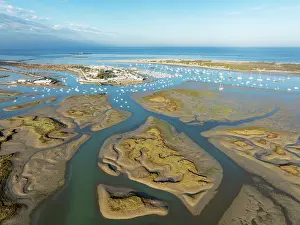 Boats: Network of channels and streams at low tide and the fishing village of Sancti Petri at the Atlantic Ocean