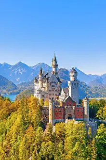 Fairytale: Neuschwanstein Castle in autumn, Alpsee behind