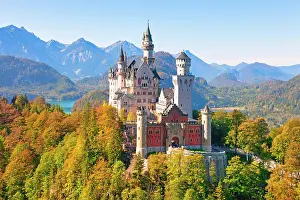 Fairytale: Neuschwanstein Castle in autumn, Alpsee behind