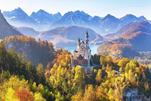 Fairytale: Neuschwanstein Castle in autumn, Alpsee behind