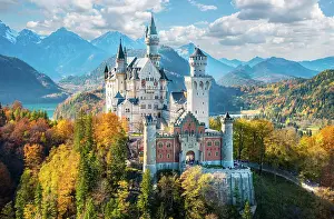 Fairytale: Neuschwanstein Castle in autumn, Alpsee behind