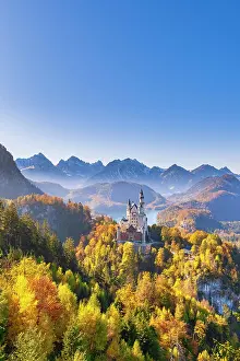 Fairytale: Neuschwanstein Castle in autumn, Alpsee behind