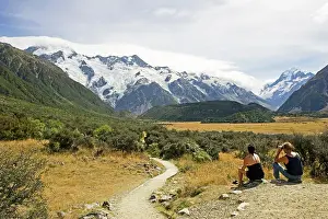 Aoraki: New Zealand - two hikers take a rest to enjoy scenery