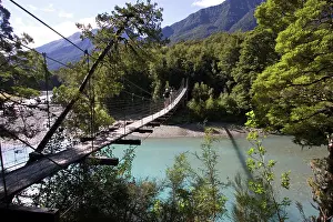 Haast: New Zealand - Tourists crossing wire suspension