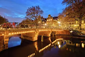 Canal: Night view of Amterdam cityscape with canal, bridge