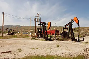 Temblor: Nodding Donkey Oil pumps in oilfield on the slopes