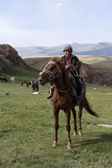 Peoples: Nomadic child riding a horse in Kyrgyzstan