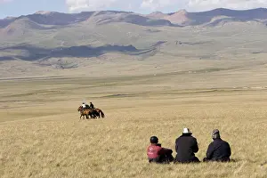 Peoples: Nomadic horsemen playing in a meadow in Kyrgyzstan