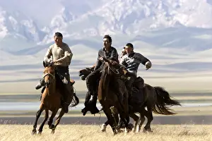 Peoples: Nomadic horsemen playing in a meadow in Kyrgyzstan
