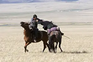 Peoples: Nomadic horsemen playing Ulach Taricht in Kyrgyzstan