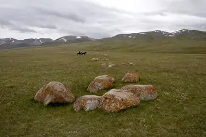 Pieces: Two Nomadic horsemen on a tableland Kyrgyzstan