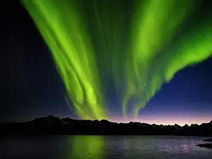 Strait: Northern lights over Angmagssalik Fjord near settlement