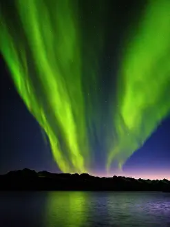 Strait: Northern lights over Angmagssalik Fjord near settlement