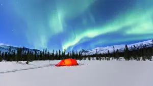 Spectacle: Northern Lights (Aurora borealis) above a red illuminated