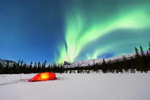 Spectacle: Northern Lights (Aurora borealis) above a red illuminated