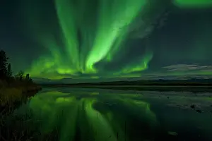 Peter Mather: Northern Lights reflected in lake at night Yukon, Canada