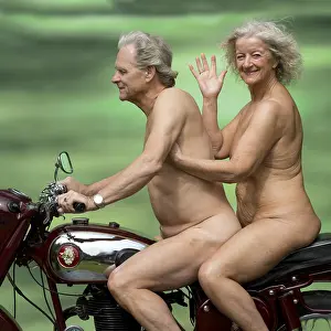 Motorcycle: Nude older couple on a motorbike