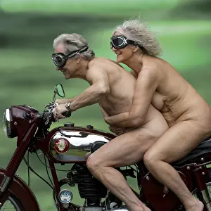 Motorcycle: Nude older couple on a motorbike
