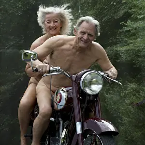 Motorcycle: Nude older couple on a motorbike