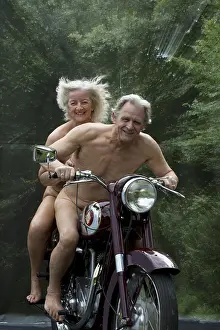 Motorcycle: NUDE older couple on an old motorbike