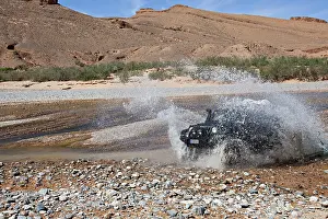 Cars: Off-road vehicle crosses a river in the Middle Atlas