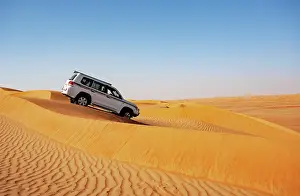 Sultanate: Off-road vehicle drives in the sand dunes, desert