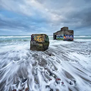 Graffiti: Old bunkers with graffiti in the surf of the Baltic