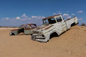 300517: Old car wreck in sand, vintage car, Ford Pickup