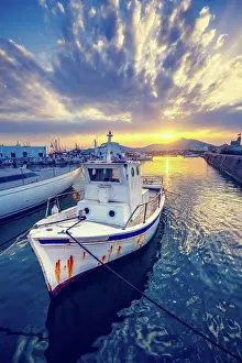Container: Old fishing boat in port of Naousa on sunset. Paros
