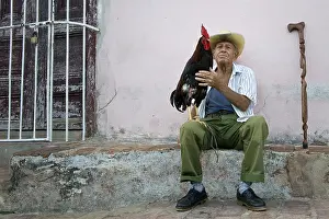 Tamed: An old man with his pet at Trinidad Cuba
