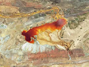 Mining: Old mining site and deep orange-red hues in the water of a pool in the mineral-rich area of the Rio Tinto mines