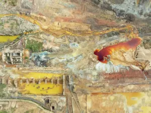 Mining: Old mining site and deep orange-red hues in the water of a pool in the mineral-rich area of the Rio Tinto mines