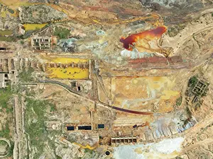 Mining: Old mining site and deep orange-red hues in the water of a pool in the mineral-rich area of the Rio Tinto mines