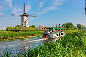 Canals: Old paddle wheel steamer on the canal between Bruges
