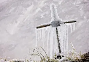 Crosses: Old roadside cross covered with frost and icicles