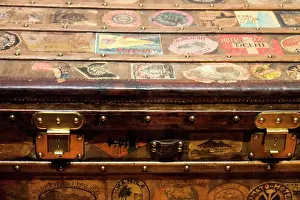 Hand: Old steamer trunk covered with stickers of various