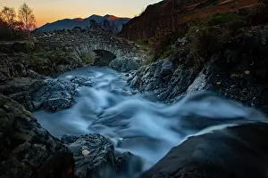 Midlands: Old stone bridge with mountain stream, behind mountains