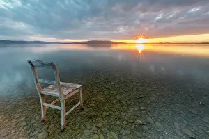 Constance: Old wooden chair in the water at cloudy sky and