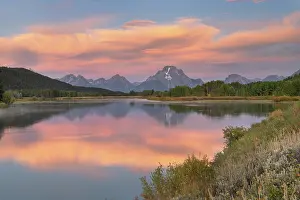 Teton: Orange clouds and Mount Moran reflected in still