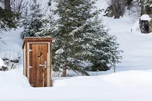 Loneliness: An outhouse in a wintry scene