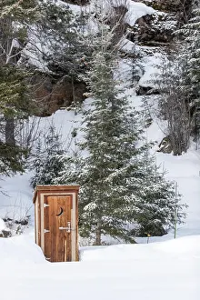 Loneliness: An outhouse in a wintry scene