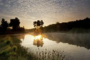 Sphere: Overview of landscape during sunrise with reflection of unid