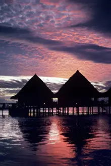 Escape: Overwater bungalows at sunset at Hotel Bali