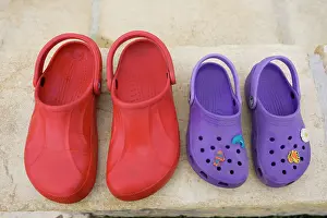 Shoes: Pair of red adult croc sandals and purple child