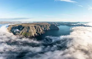 Distant: Panorama of the cliffs of the North Cape with foggy
